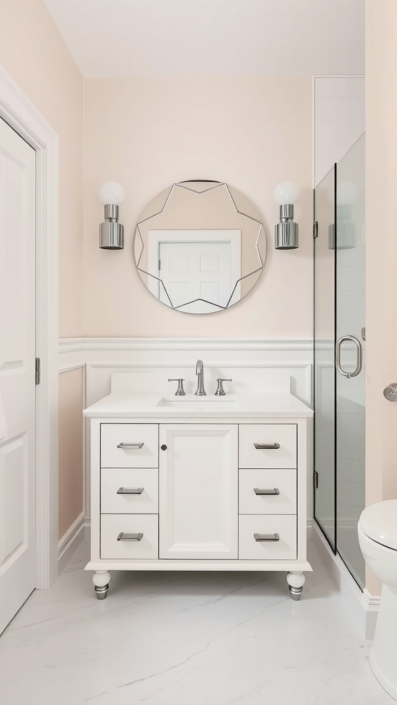 Bright and airy Art Deco bathroom with peach walls, a round starburst mirror, a white vanity, and a glass shower.